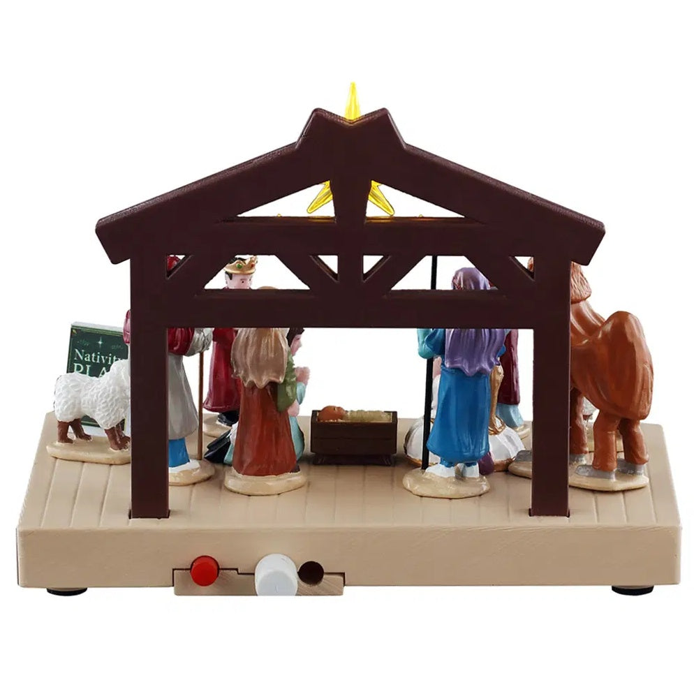 This image shows what this table accent looks like from the back. There's a manger with baby Jesus in it. You can also see two of the buttons used to turn this table accent on.