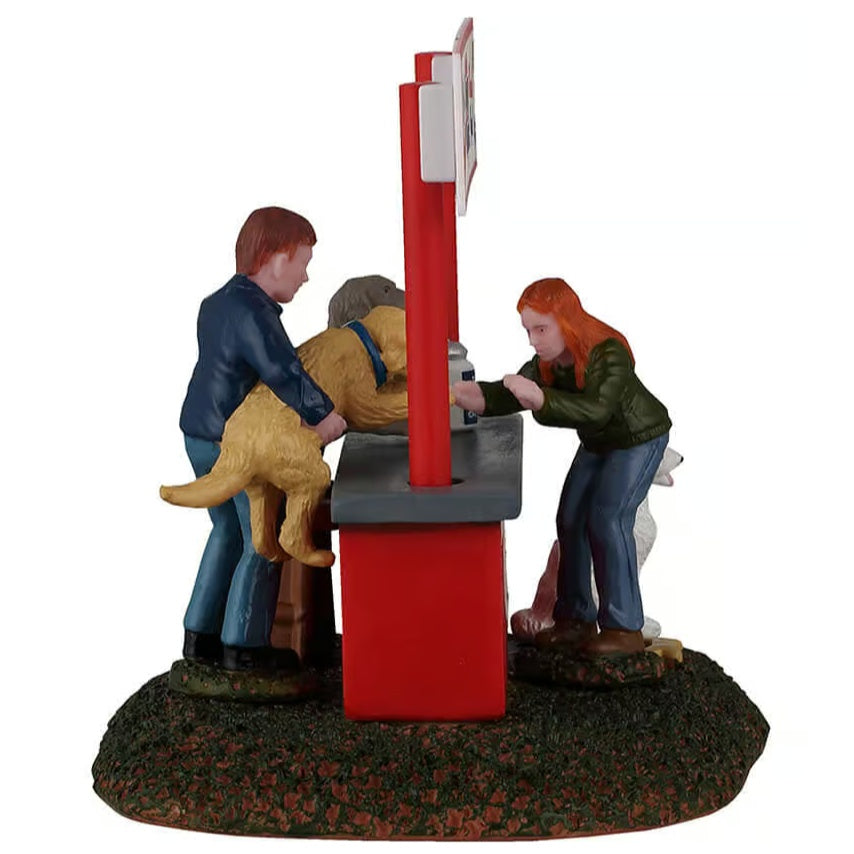 This image shows what this table accent looks like from the side. The man is holding a golden retriever up over the counter so the woman in front can give him a kiss.