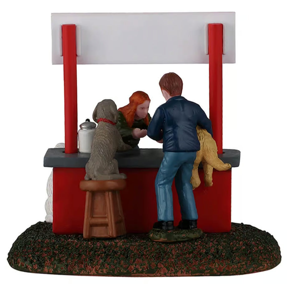 This image shows what this table piece looks like from the back. There's a dog sitting on a stool next to the man standing and holding the golden retriever.