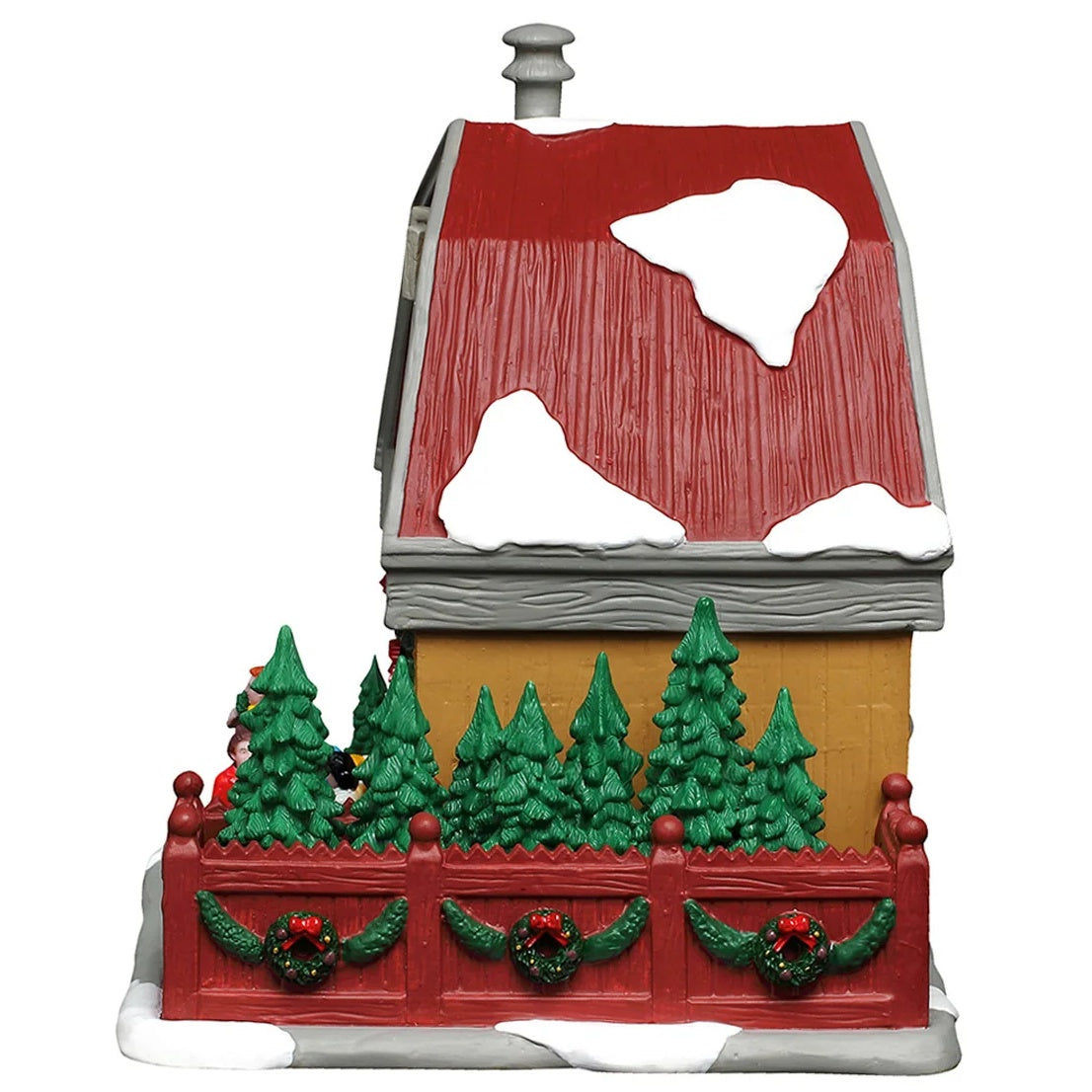 This image shows what the other side of this building looks like. The fenced in area has lots of trees. The fence is decorated with wreaths and garlands.