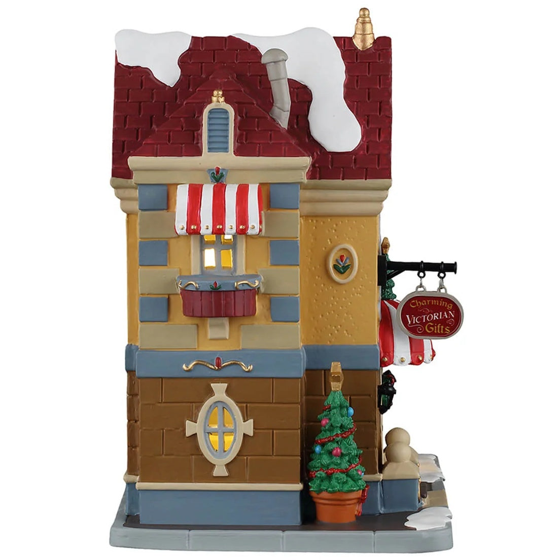 This image shows what the side of this building looks like. There's a window with a planter underneath it. There's a potted Christmas tree next to the front door.