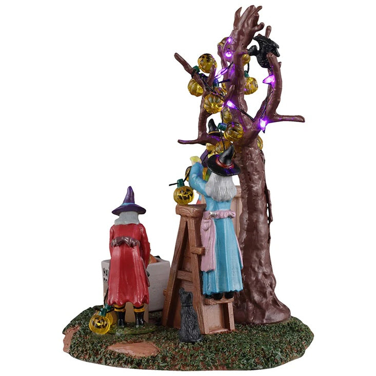 This is another angle of this piece. You can see a witch standing on a ladder and another witch digging through a box.