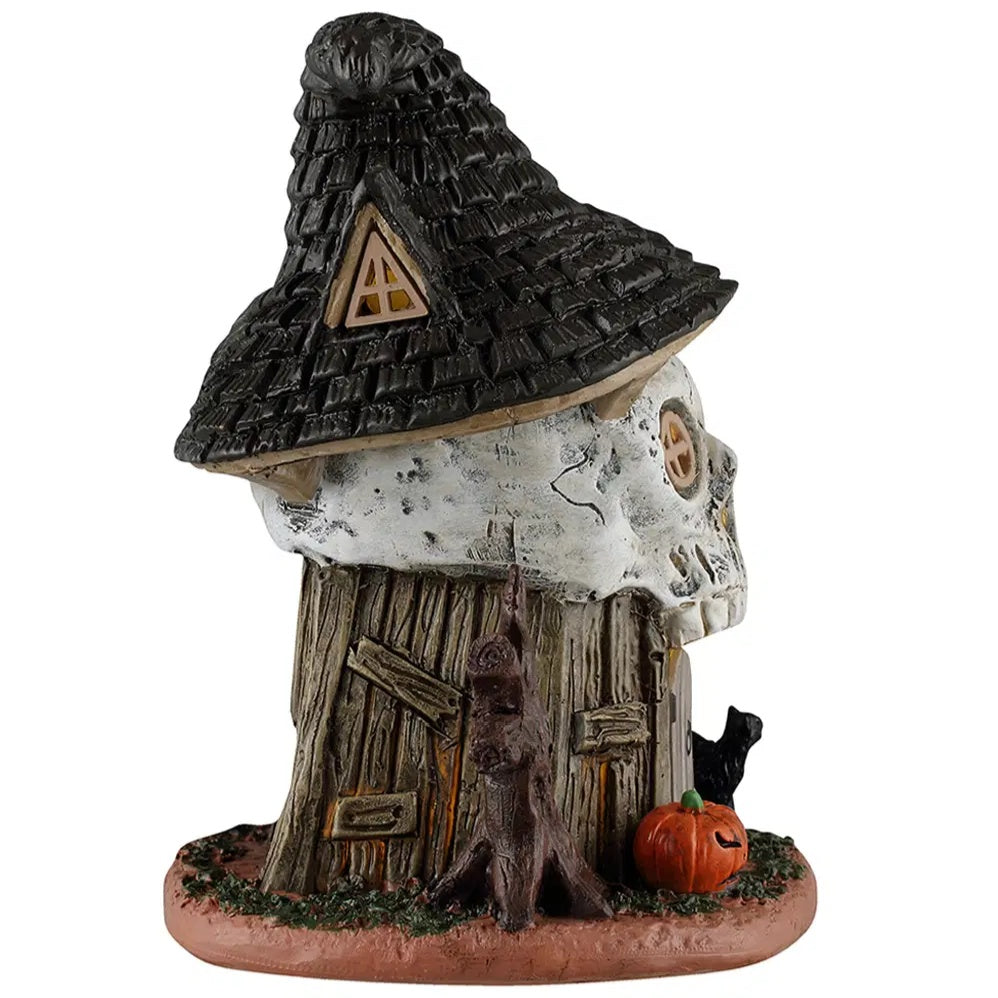 This is the side of this table accent. There's a window in the roof/hat. You can see a bare tree next to the door, along with a jack-o-lantern.