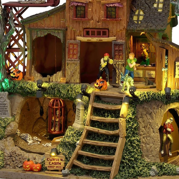 This is an up close view of part of the cabin. You can see the skeleton in the cage, there are also some other bones on the ground underneath him. On the other side of the house, you can see a skeleton trying to climb a rope upstairs.