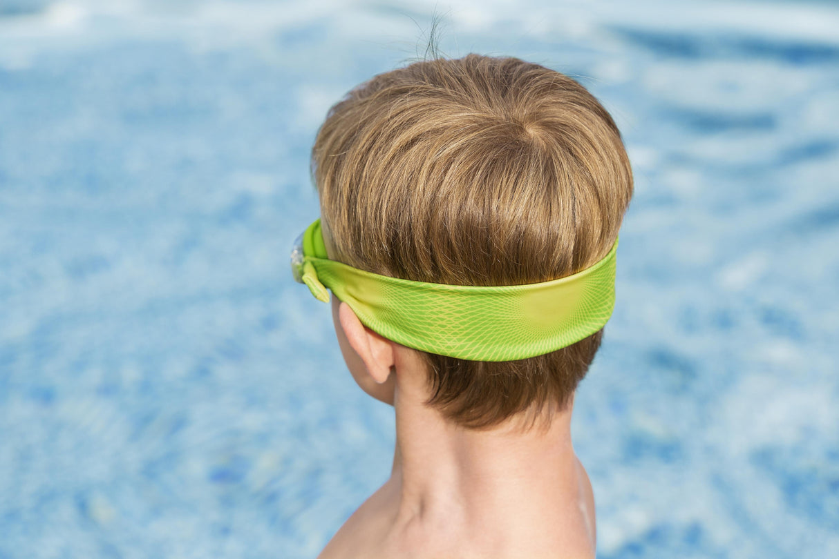 This is a lifestyle image showing the back of a young boy's head wearing the goggles. It shows off the unique stretchy lycra fabric design, in the lime green and yellow color option.