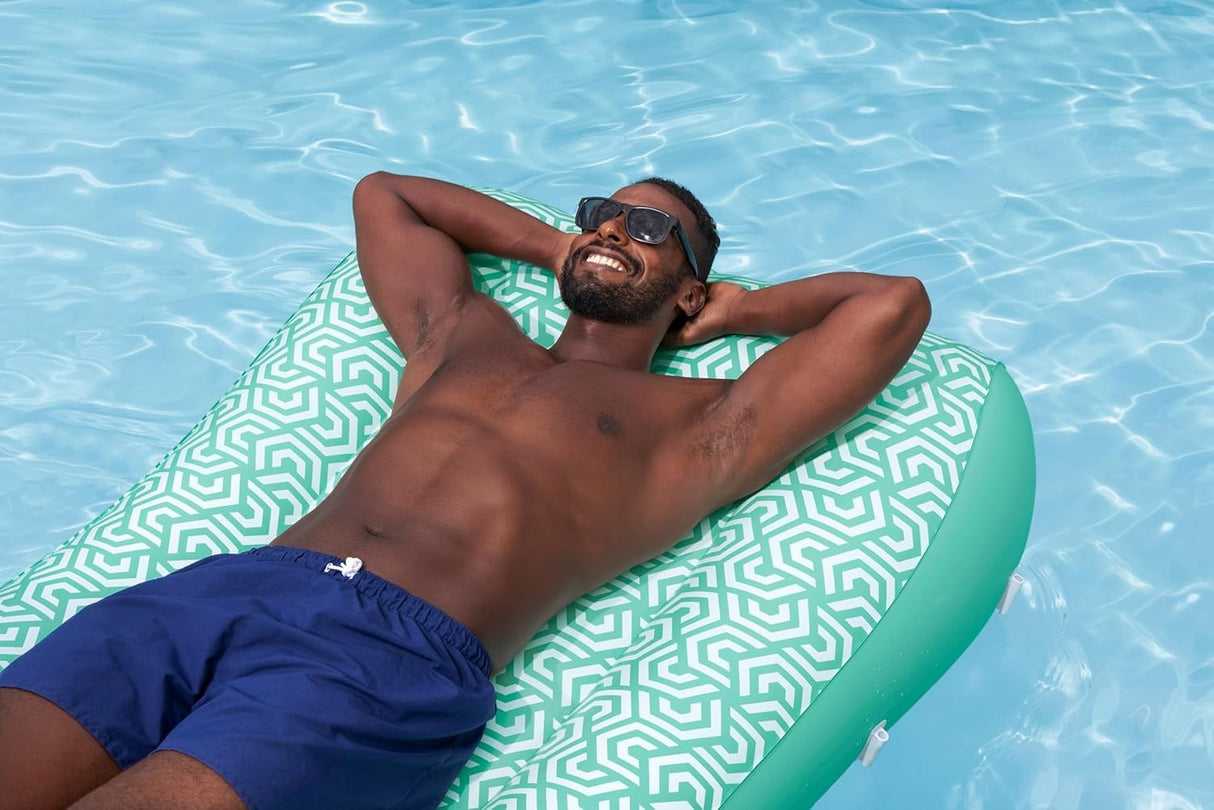 This is a lifestyle image showing a man resting on the float in a pool. The sunshade is not attached.