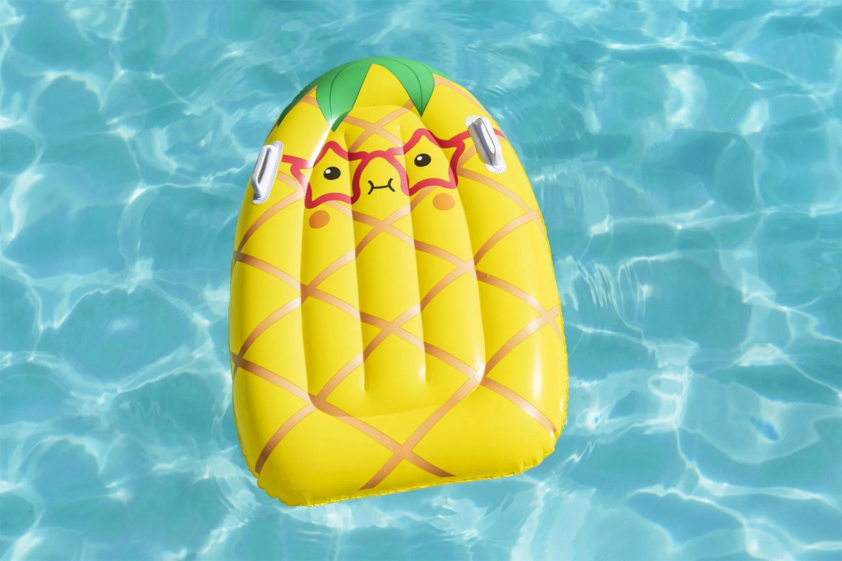 This is a lifestyle image showing the pineapple surf rider float in the water.