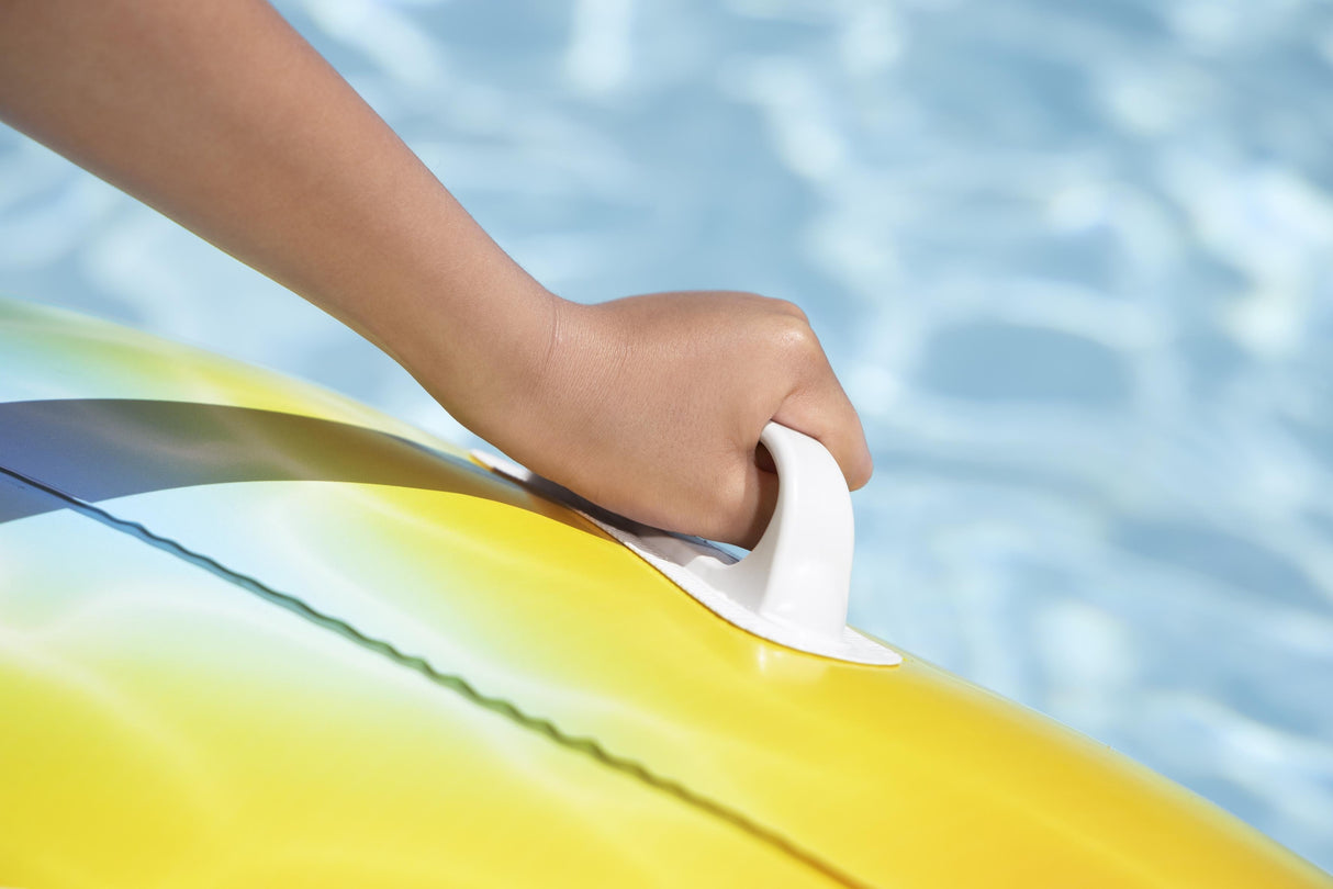This image is a close-up view of a child's hand holding onto the white handle.