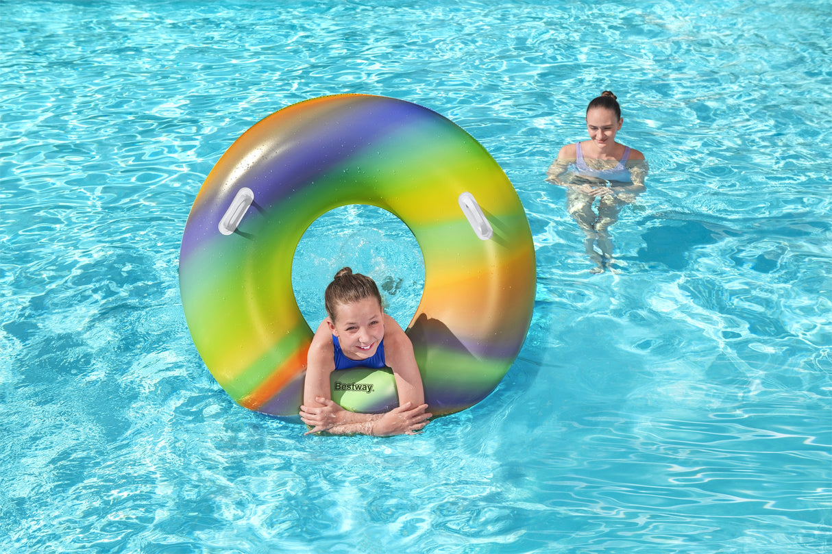 This is a lifestyle image showing a young girl inside the inner tube in the water.