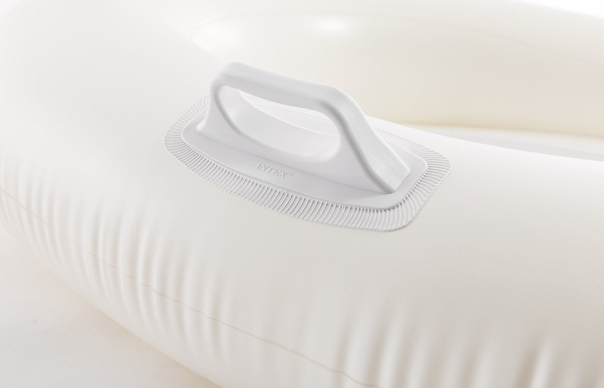 This is an up close view of the white pool chair's white handle.