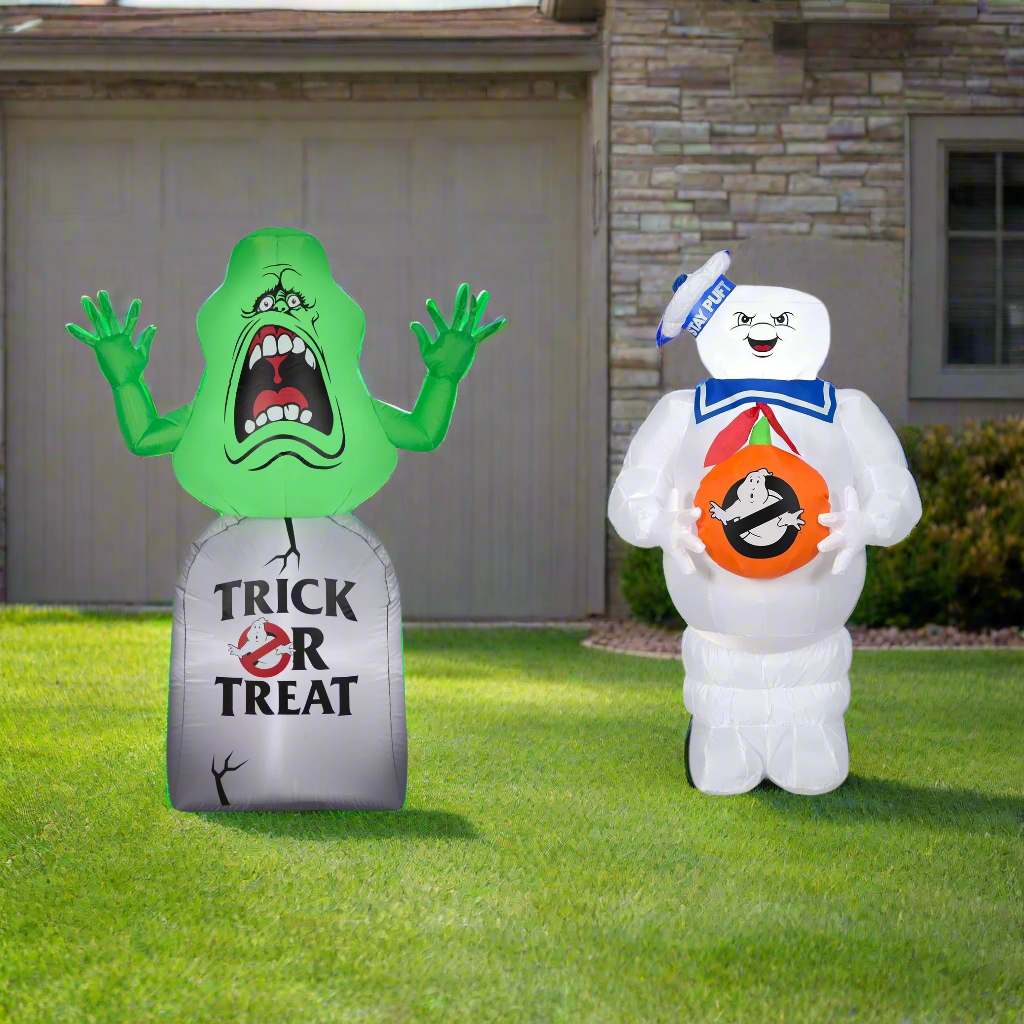 This image shows the two Ghostbusters inflatable decorations on the lawn in front a house.