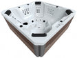 A square-shaped hot tub that seats 7 people. This image is taken from above so you can see inside.