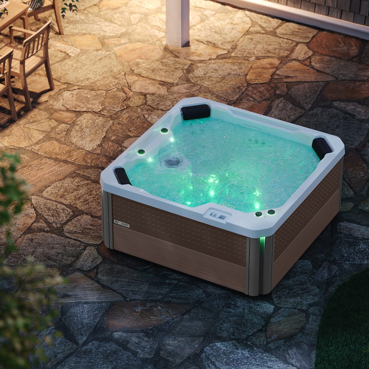This is a lifestyle image of this hot tub from above. It's filled with water and the lights inside are on (they're green).