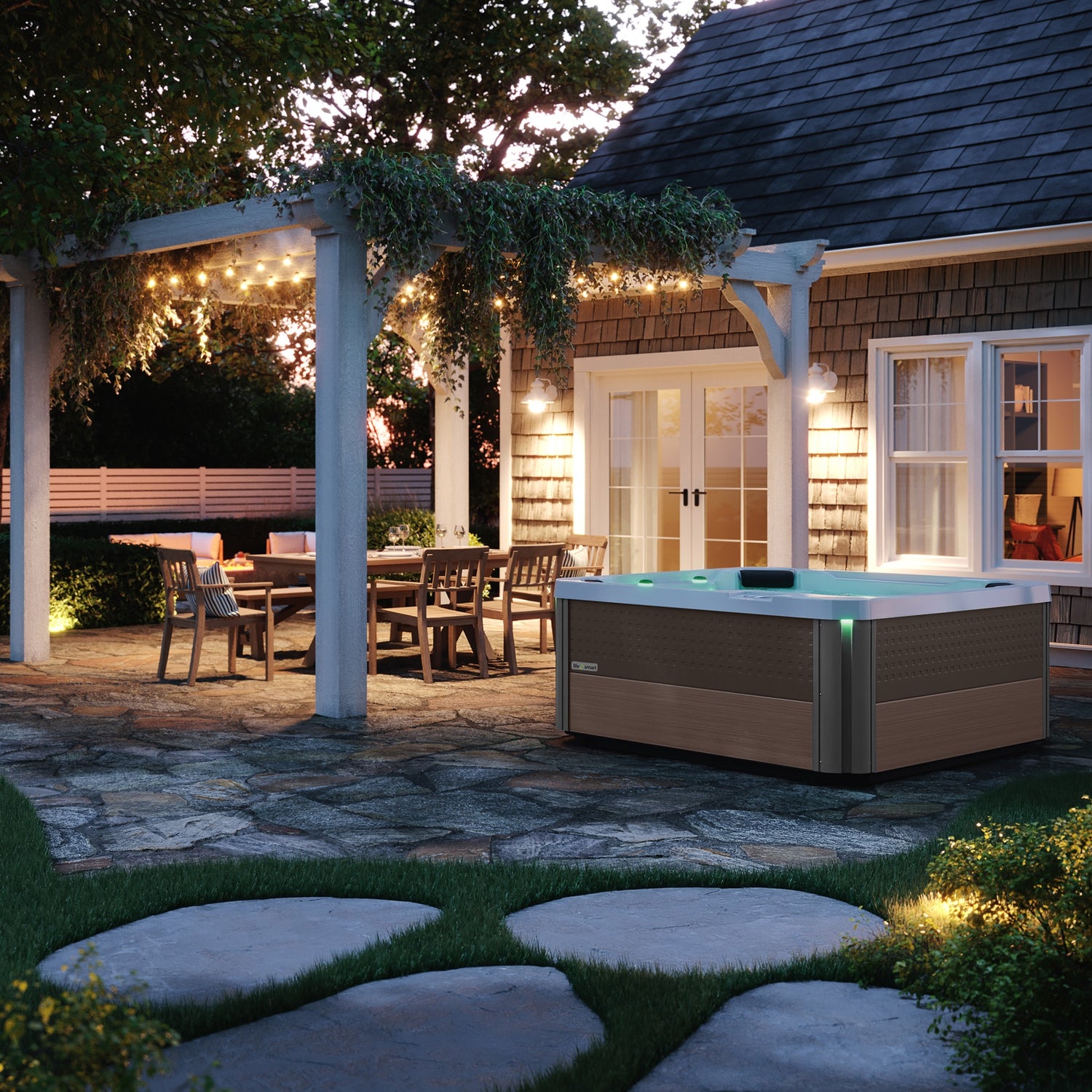 This is a lifestyle image showing the hot tub on a stone patio near a white sun shelter with some patio dining furniture underneath.