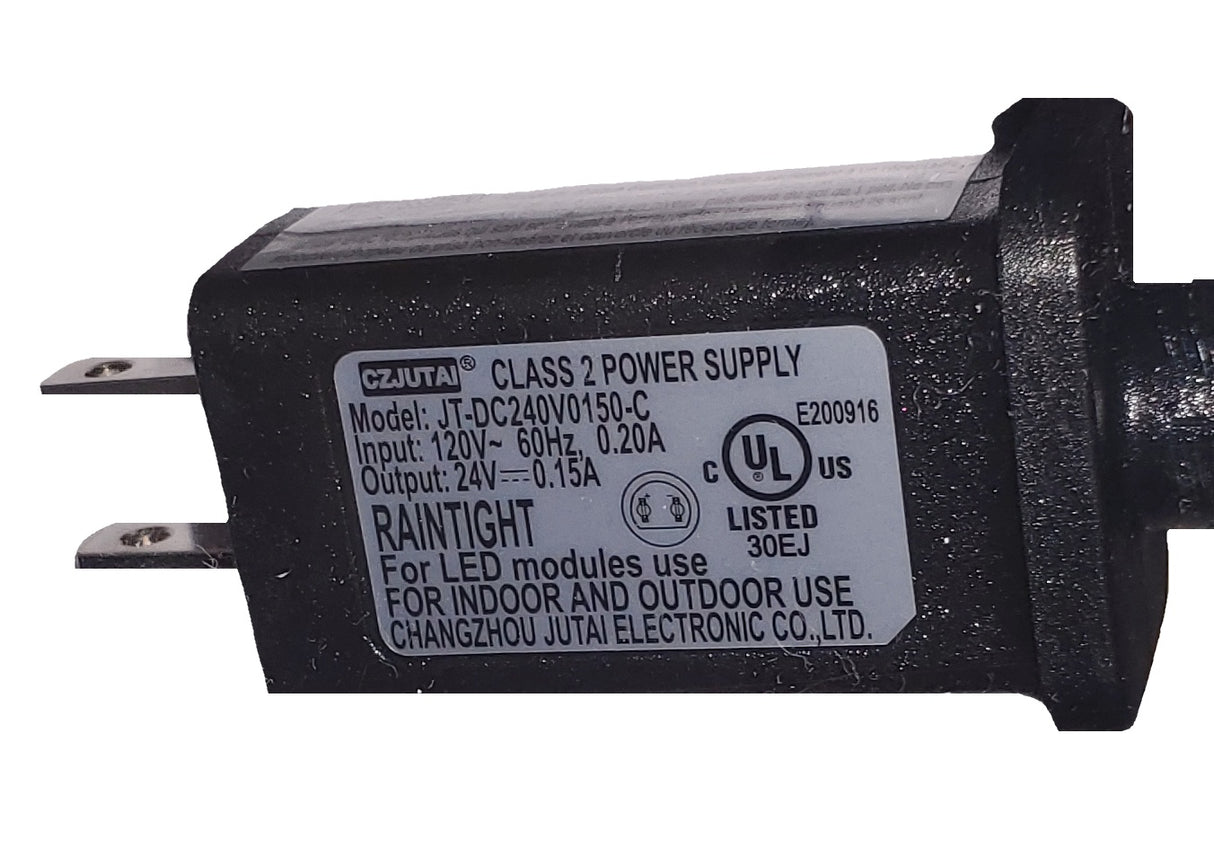 This image shows the plug for this light burst decoration on a white background. The plug has a sticker on it that reads "Czjutai Class 2 Power Supply. Input: 120V~ 60Hz, 0.20A. Output: 24V, 0.15A. Raintight. For LED modules use. For indoor and outdoor use. UL listed."