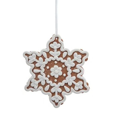 This image shows the ornament shaped like a gingerbread snowflake. It has swirly white "frosting" accents in the center.