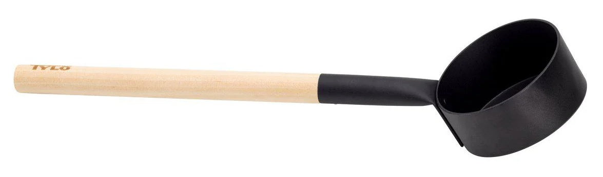 A sauna ladle from Tylo. The scoop part is made of black aluminum and the handle is made of birch and aspen wood.