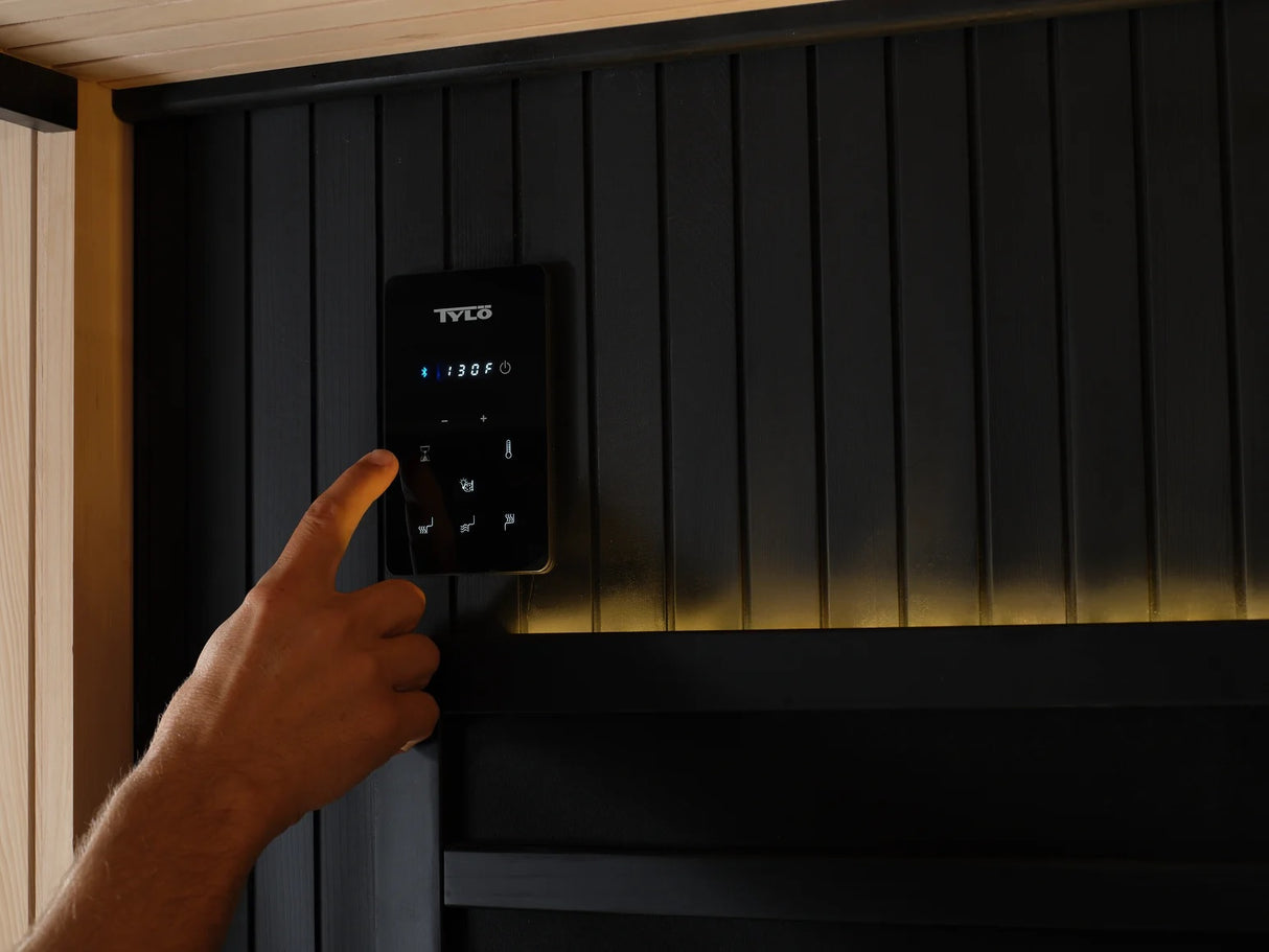 This image shows someone adjusting the temperature inside the sauna.