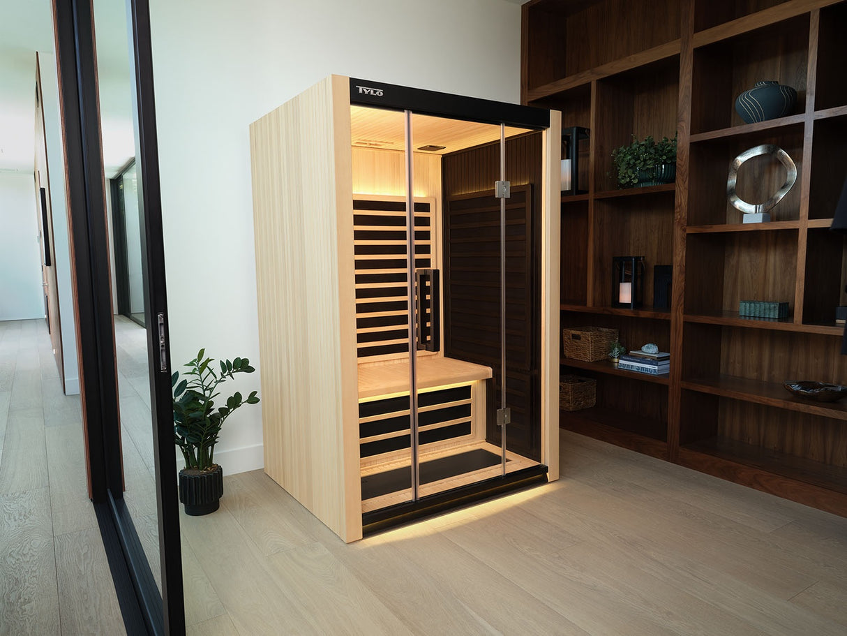 A light brown, 1-person sauna inside someone's home.