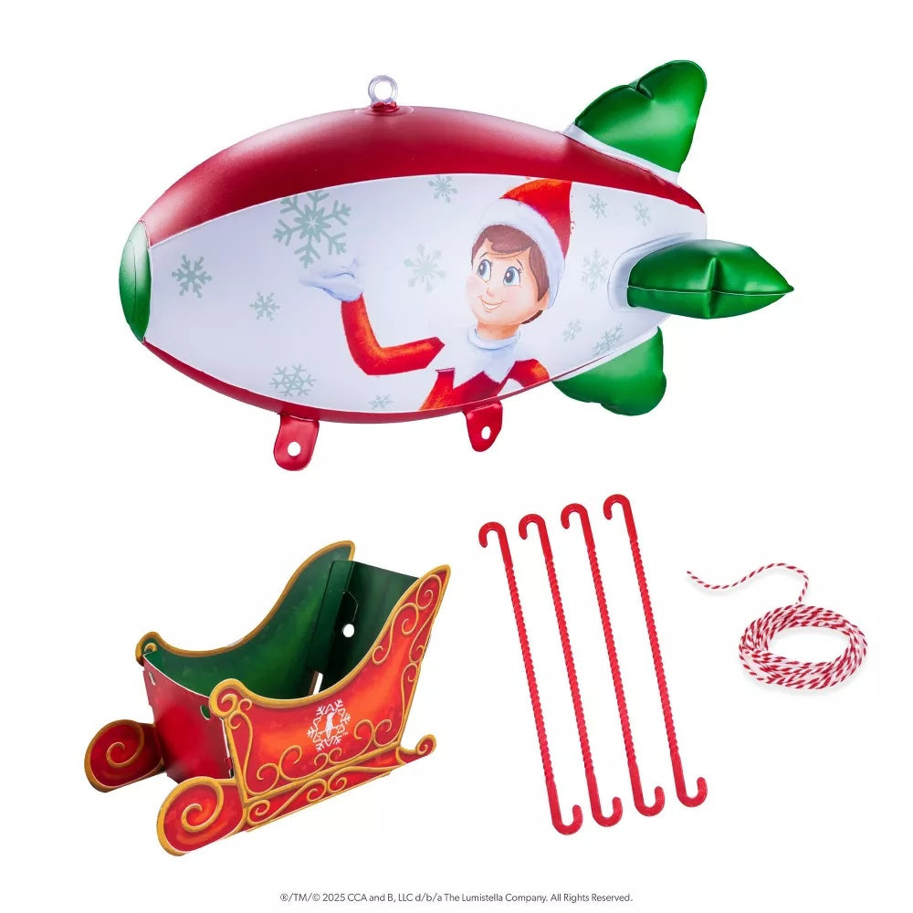 This image shows everything that's included in this blimp package. The inflatable blimp, the paperboard sleigh and 4 plastic supports.