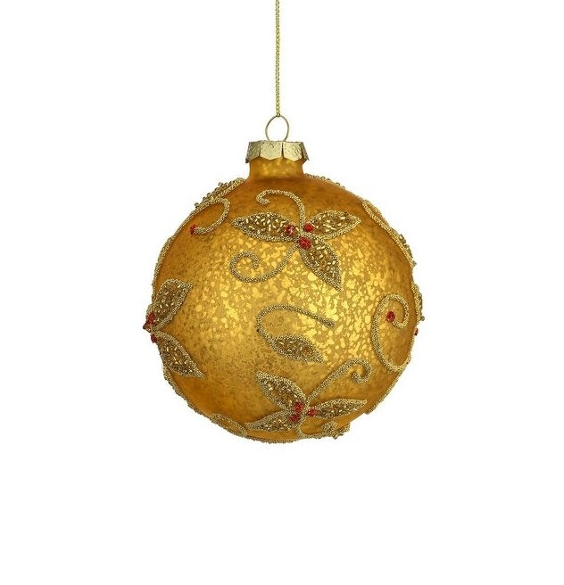This image shows the round ornament. It has a gold base with beaded gold swirly flower designs. Inside the flowers, there are red accents.