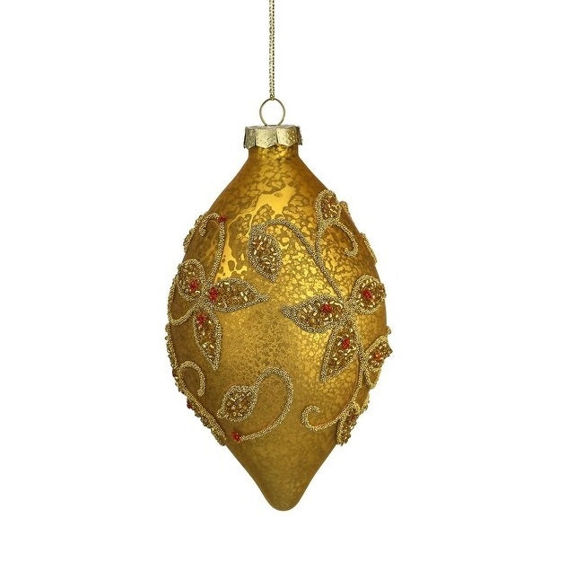 This image shows the finial ornament. It has a gold base with beaded gold swirly flower designs. Inside the flowers, there are red accents.