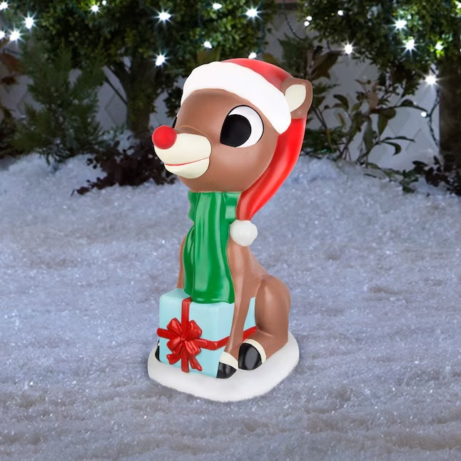 This is a lifestyle image showing this Rudolph blow mold decoration in the snow.