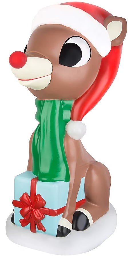 This image shows a Rudolph blow mold decoration. He's wearing a Santa hat and a green scarf. He's holding a light blue present that has a red bow on it.