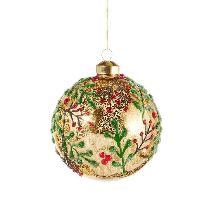 This ornament is round and gold with green leaves, brown stems and red berries.