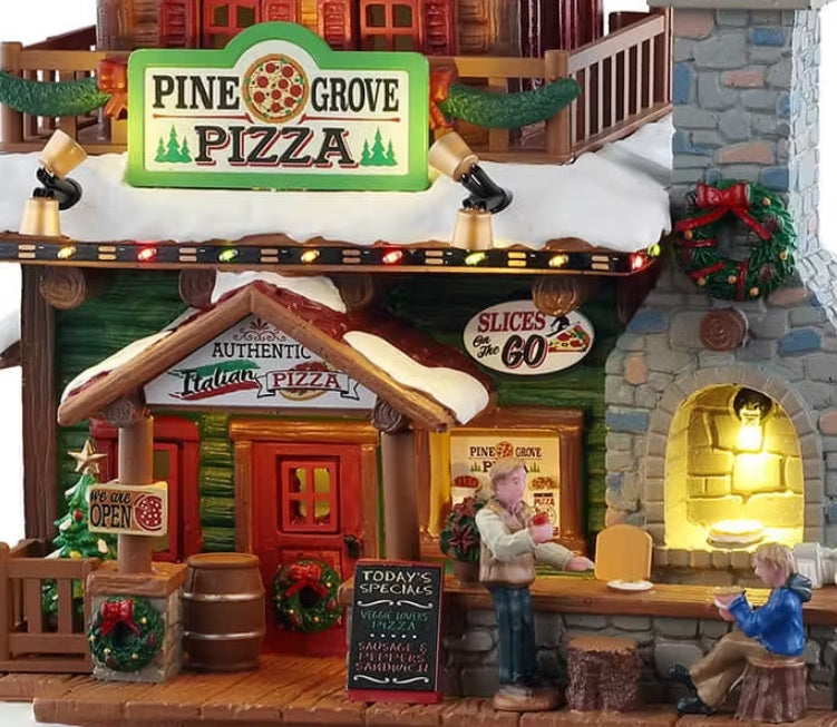 This is an up close view of the building. There's a sign on the sidewalk by the bar that reads "TODAY'S SPECIALS: VEGGIE LOVER'S PIZZA and SAUSAGE & PEPPERS SANDWICH."