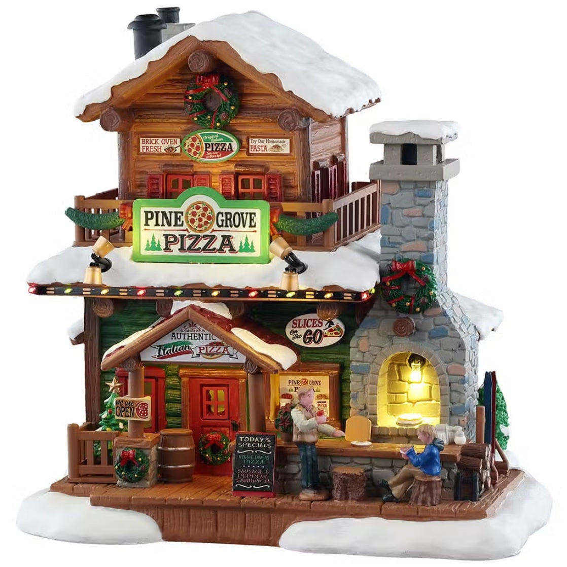 This is a Lemax lighted building designed to look like a two story pizza restaurant. There's snow on the roof and on the sidewalk. It's decorated with wreaths and garlands. There are people at the bar on the right side in front of a wood fired stove.
