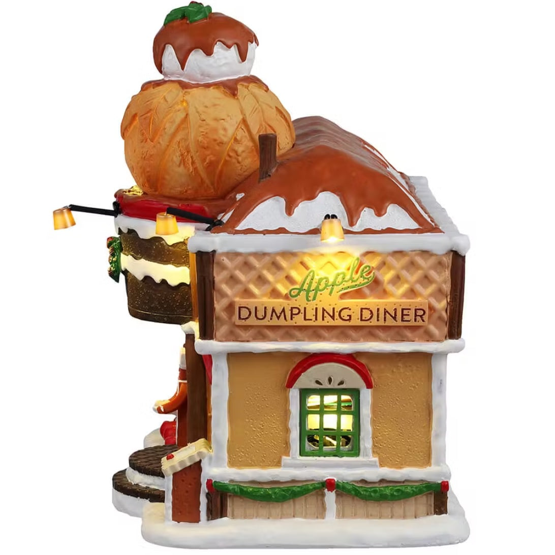 This is the side of the building. There's a light over the sign that reads "APPLE DUMPLING DINER" and you can see light coming through the window.