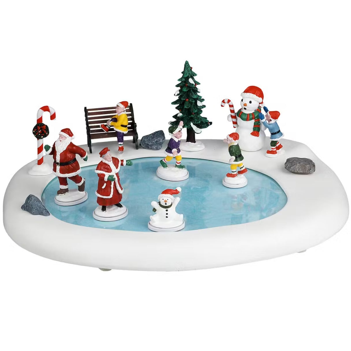 This is a Lemax table accent designed to look like a circular ice rink surrounded by snow. There's a child on a bench lacing up his skates. There's a decorative candy cane and a small snow-covered tree. Santa, Mrs. Claus, two elves and a snowman are skating around. On the edge of the rink, there's a child decorating a snowman.