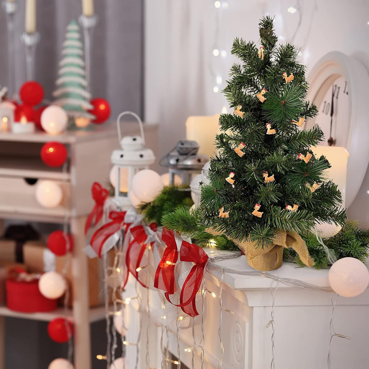 This is a lifestyle image showing a small tabletop tree on a mantel in a room decorated for Christmas. There are Rudolph lights on the tree.