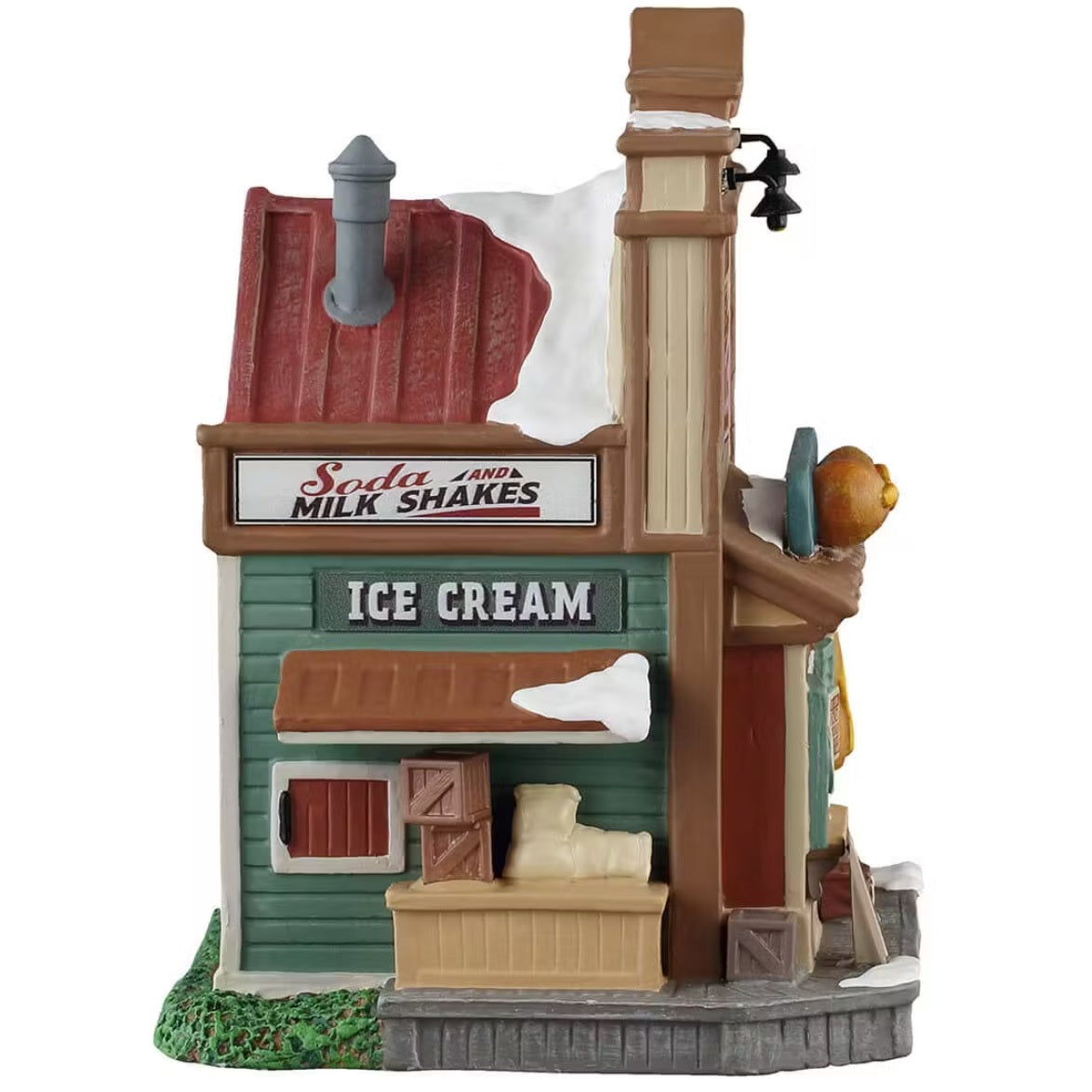 This is the side of the building. There's snow on the roof and on the sidewalk. There are two signs that read "SODA AND MILK SHAKES" and "ICE CREAM."
