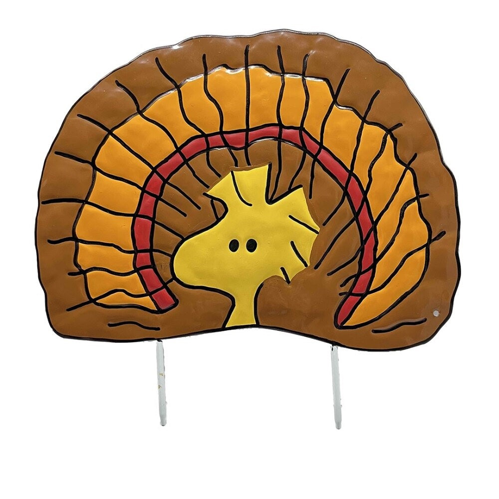 This is an up close view of the pumpkin press-in decoration. Designed to look like the yellow bird from the Peanuts cartoons: Woodstock. He has brown, red and orange feathers behind him so he looks like a turkey.