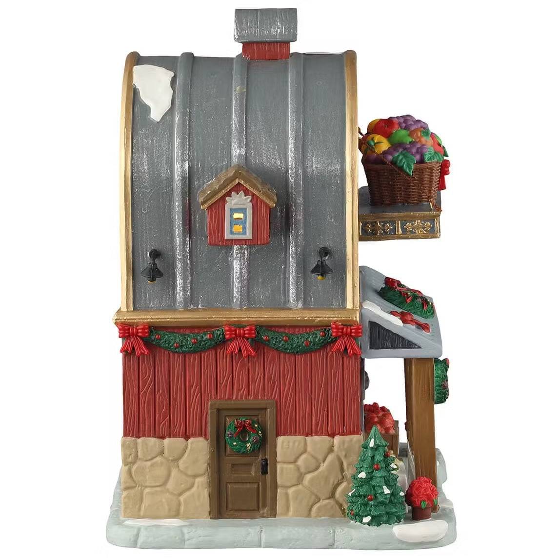 This is the other side of the building. There's snow on the roof and on the sidewalk. There's a small window and a door with a wreath on it.