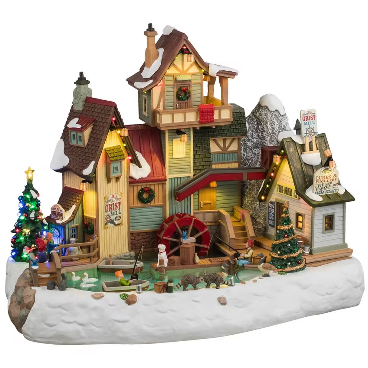 This is a Lemax animated building designed to look like a flour mill. It's a multi-colored house with a pond in front of it. There are people fishing, there are ducks swimming, a dog looking over the dock and two raccoons standing next to the pond. There are two decorated Christmas trees and snow everywhere.