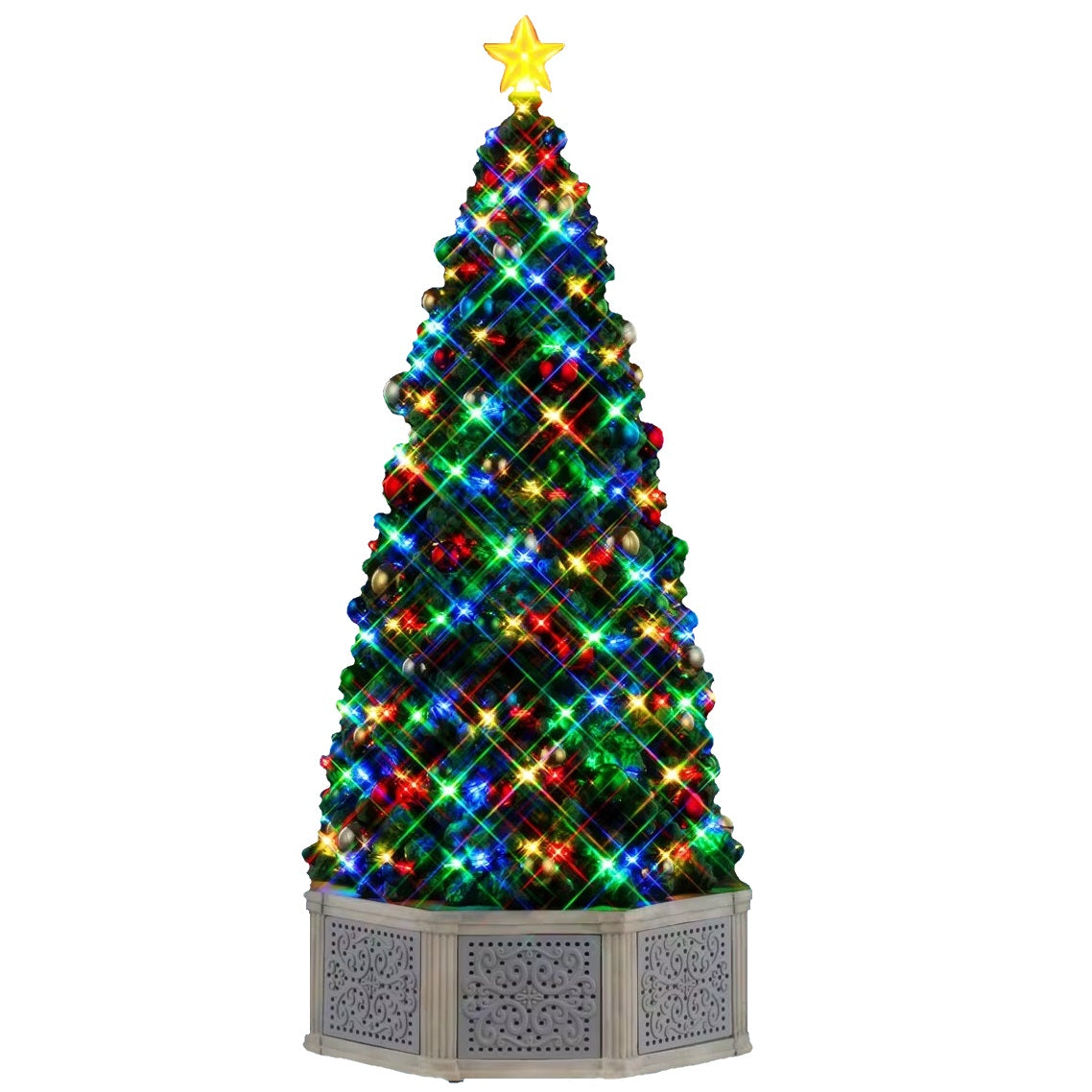 This is a Lemax lighted tree. There's a star on the top, lights throughout and shiny ornaments. There's a gray fence around the base of the tree.