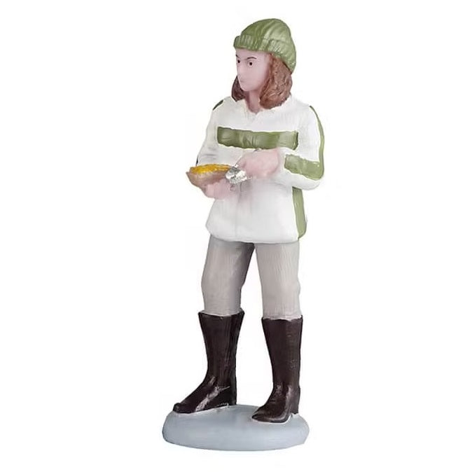 This person is wearing a forest green colored winter hat, a white and forest green colored jacket, tan pants and brown boots. She's holding food in her hand.