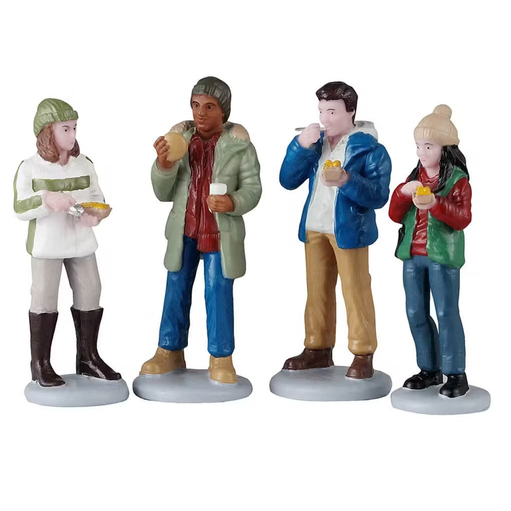 This is a set of four Lemax figurines designed to look like a group of people eating.