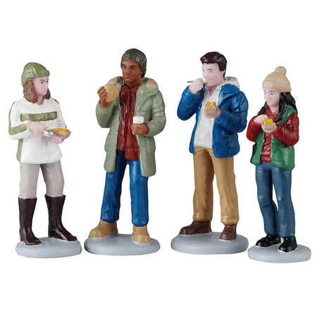 This is a set of four Lemax figurines designed to look like a group of people eating.