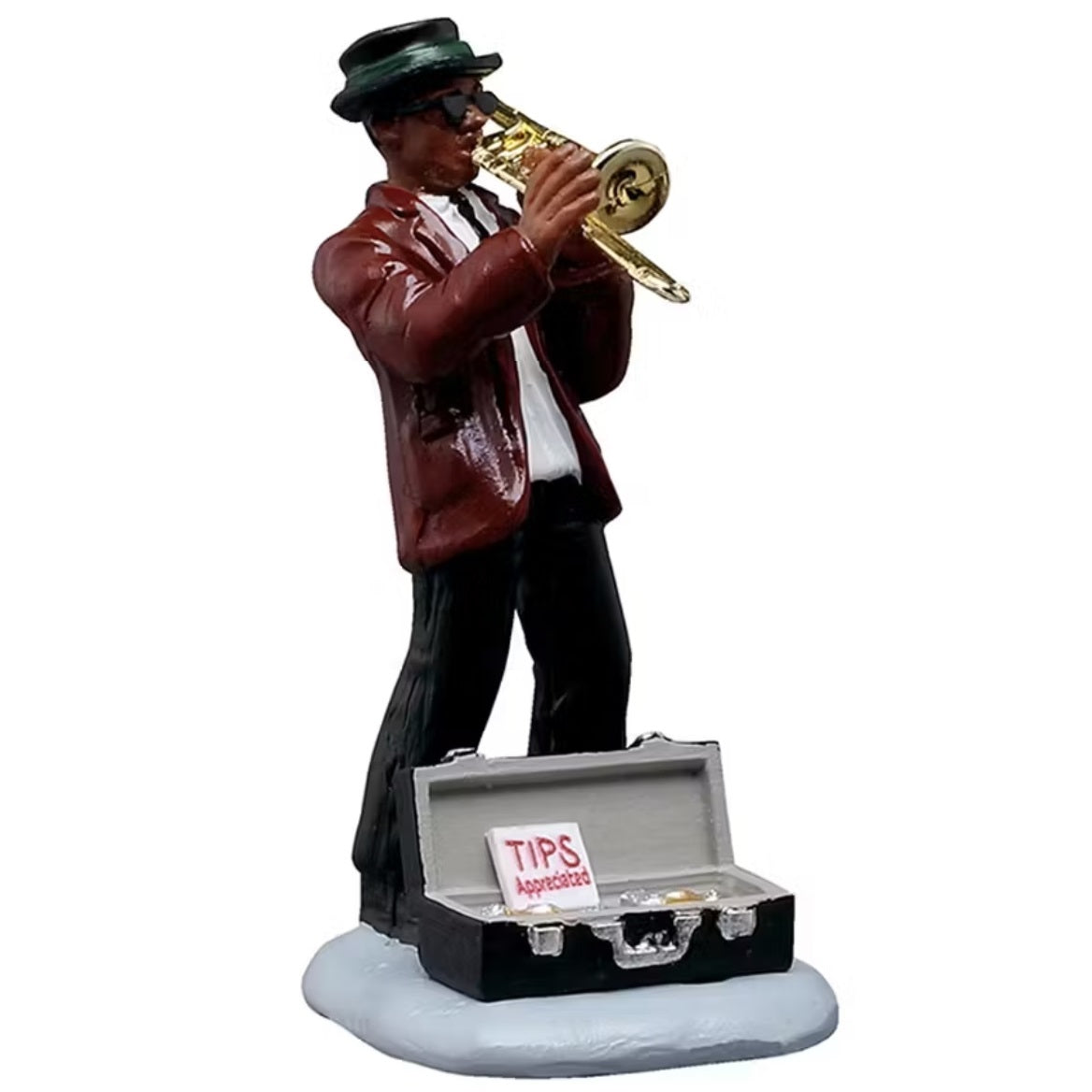 This figurine is a man playing the trombone. He's wearing a black top hat, black sunglasses, a maroon colored suit jacket, a white shirt and black pants. In front of him is an open case with a sign that reads "TIPS APPRECIATED."
