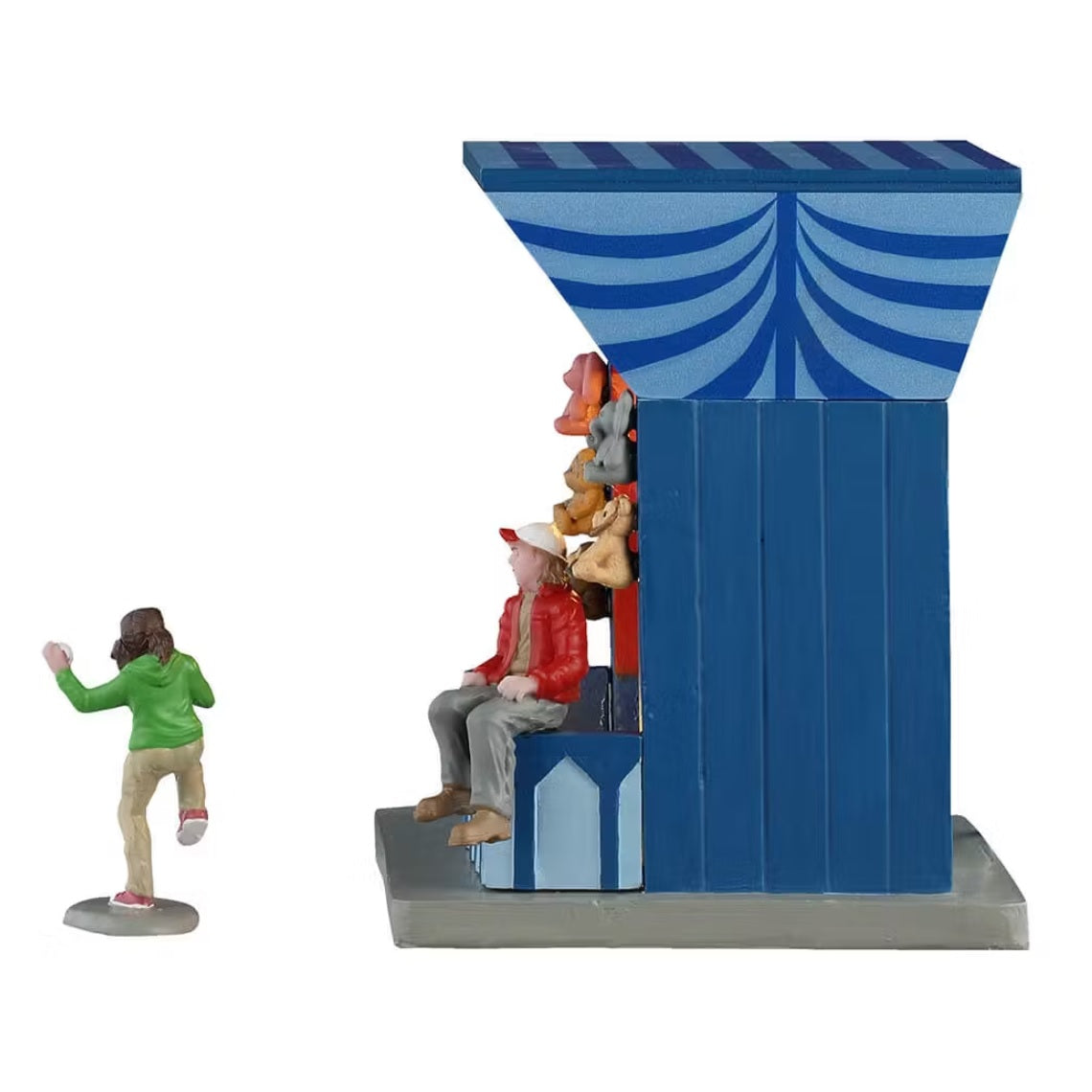 This is the other side profile of this Lemax booth. You can see the girl gearing up to throw the ball and you can see the booth worker sitting on the booth table.