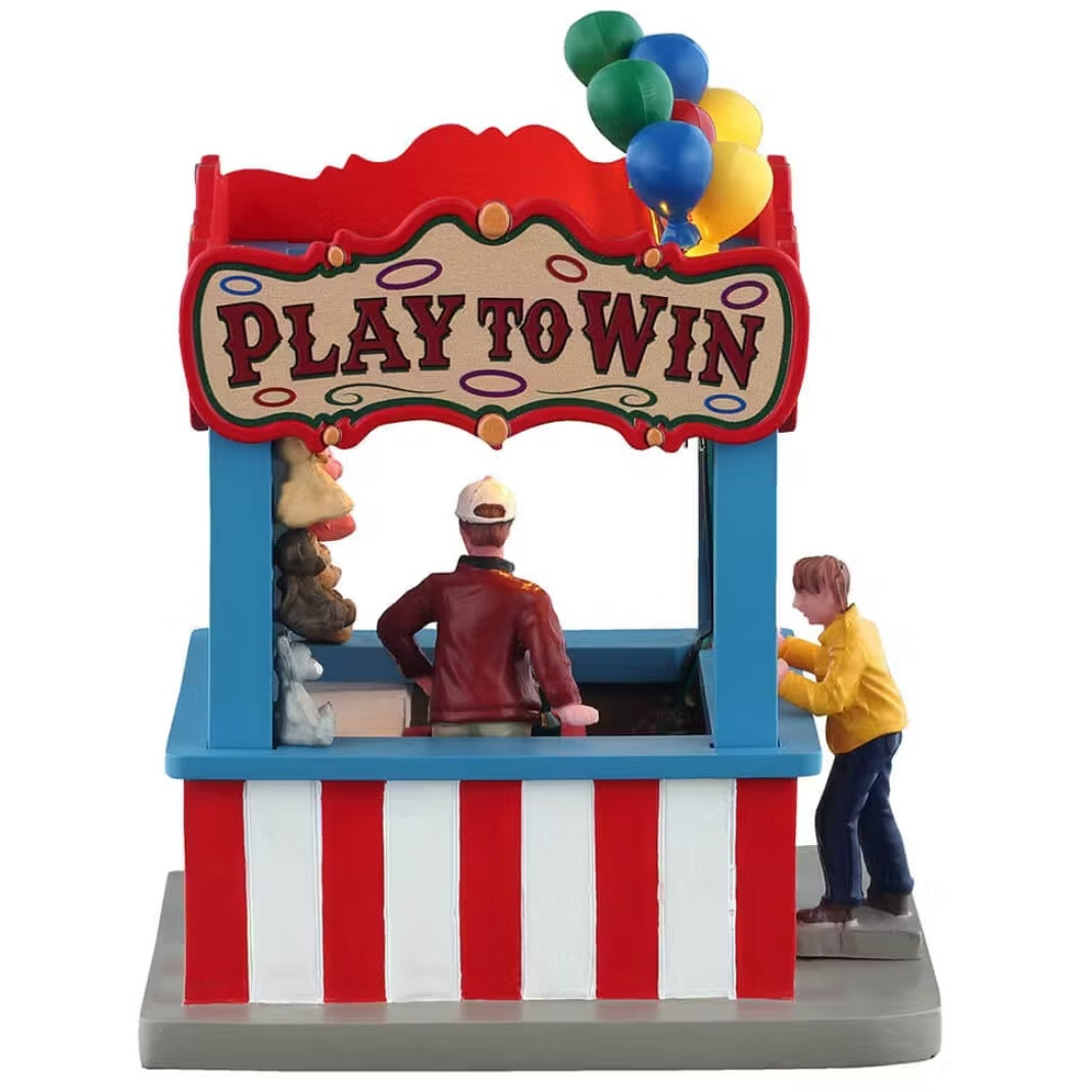 This is the side of the Ring Toss booth. The sign up top reads "PLAY TO WIN."