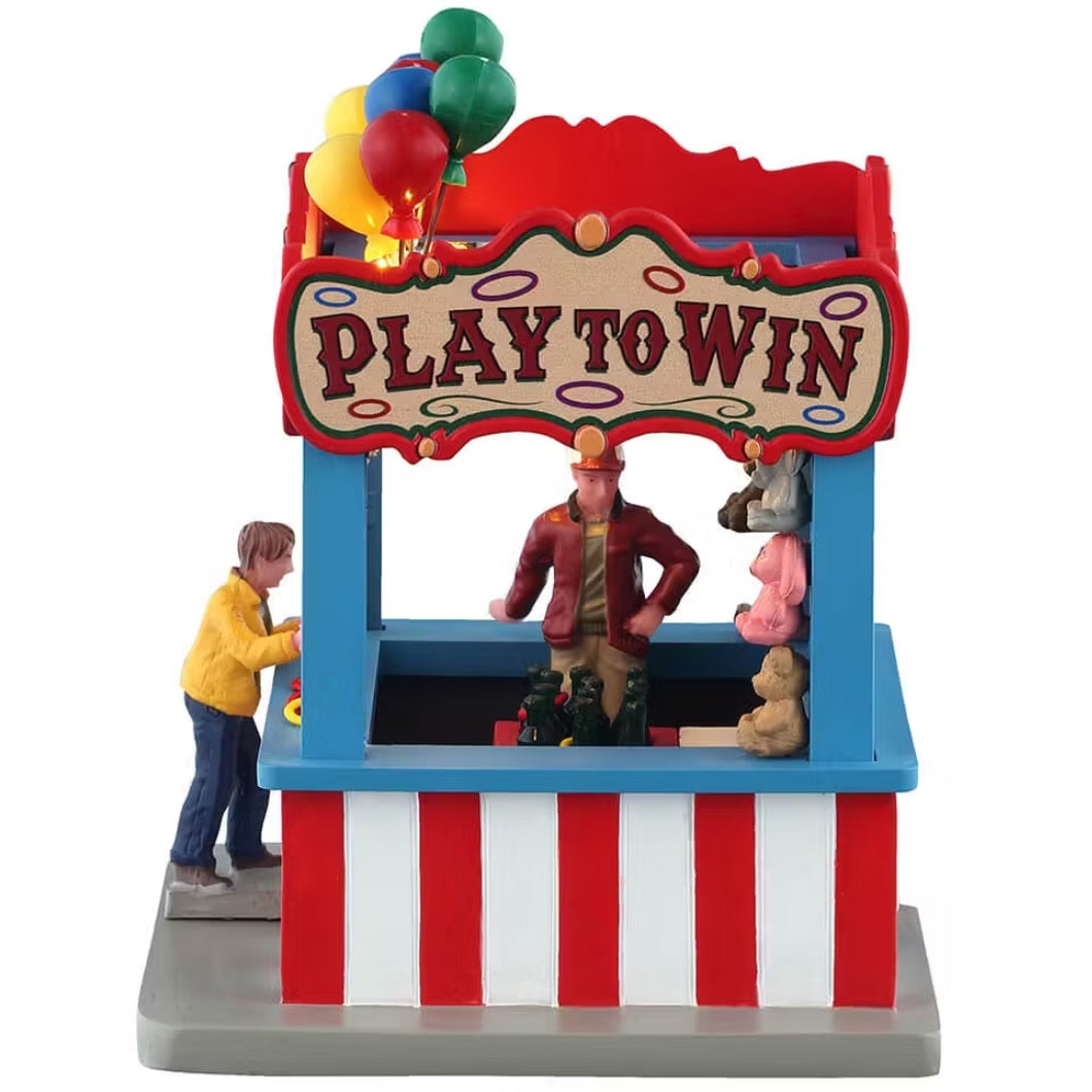 This is the other side of the Ring Toss booth. The sign up top reads "PLAY TO WIN." You can see inside the booth.