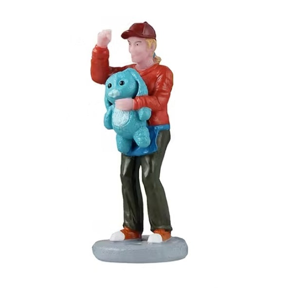 This image shows a person fist pumping and holding a blue stuffed animal shaped like a bunny.