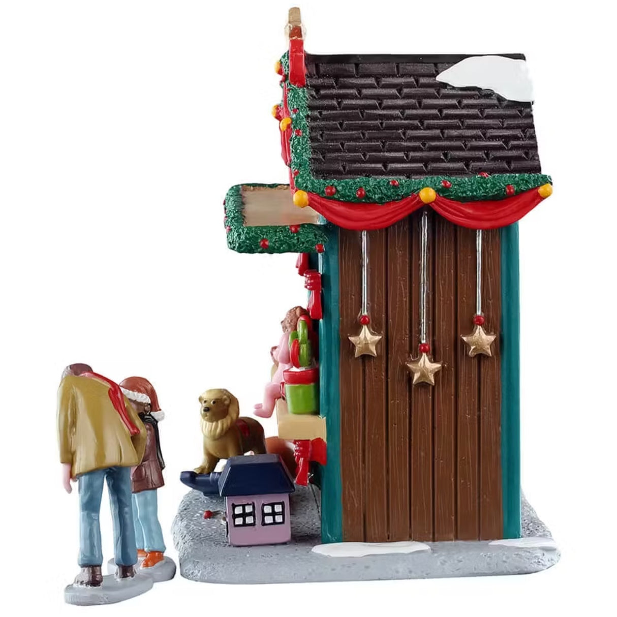 This is the other side of the booth. There's snow on the roof and three gold stars dangling from the roof. You can see a small pink dollhouse near the base of the booth.