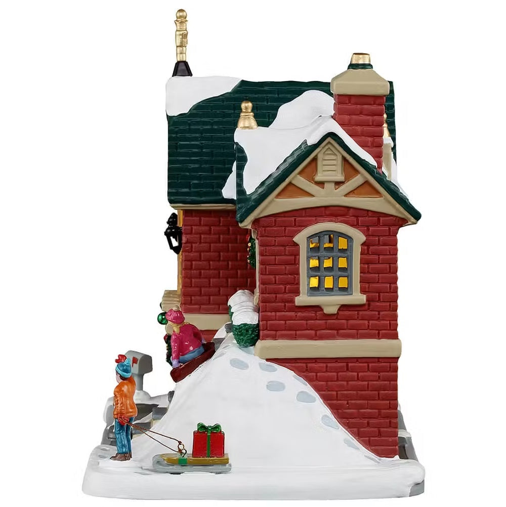 This is the side of the building. You can see footprints leading up the hill to where the girl is sledding.