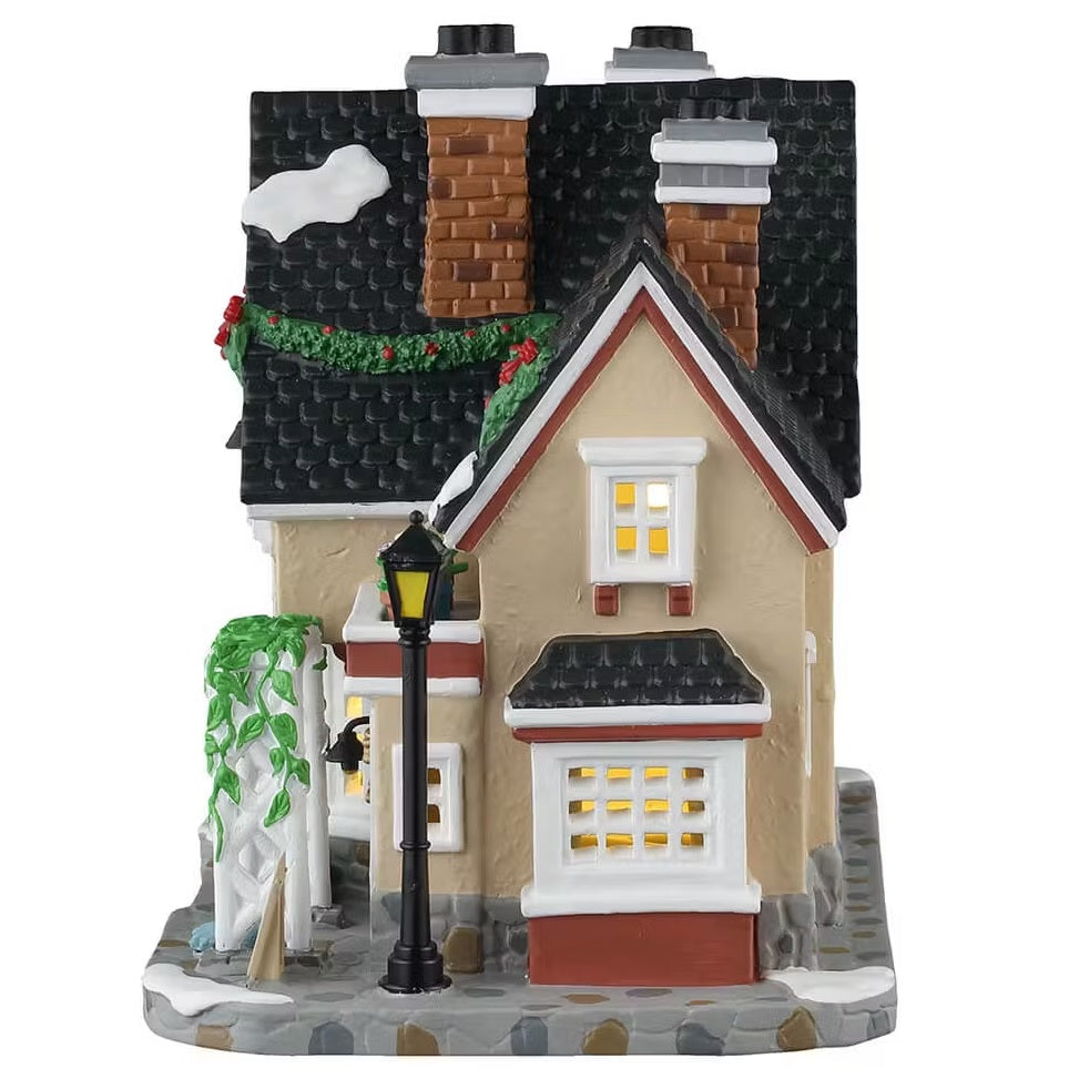 This is the other side of the building. There are three windows with lights shining through.